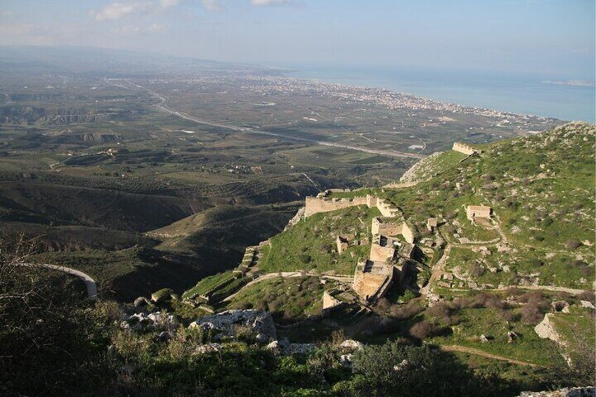 A historical fortification on a hill overlooking a coastal city. 5