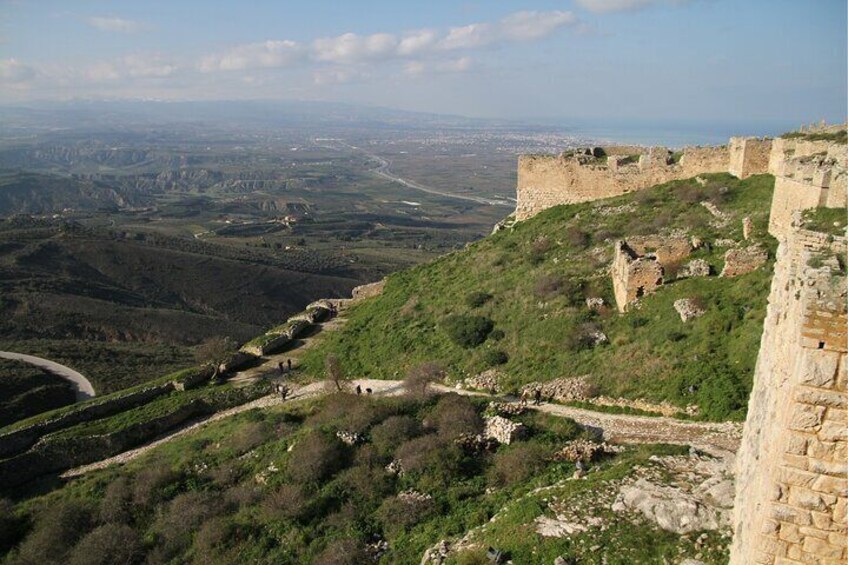 A historical stone fortress on a hill overlooking a valley. 3