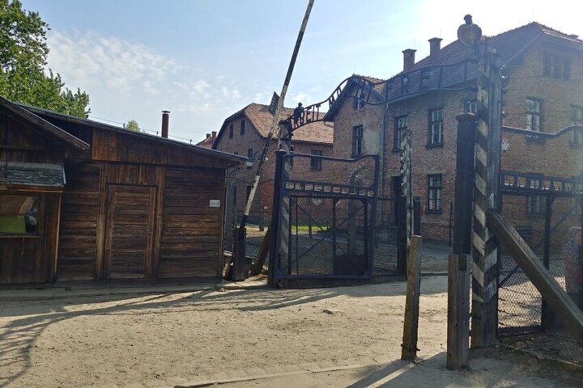 A historical building with a wooden structure and a brick building in the background. 1