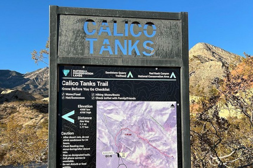 A trail sign for the Calico Tanks Trail with a map and elevation details. 4