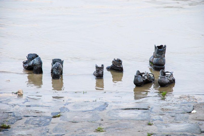 A group of boots floating in a muddy water body. 2