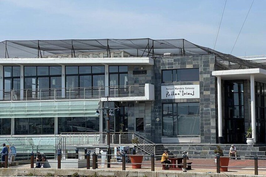 A modern building with a sign reading 'Nelson Mandela Gateway.' 4