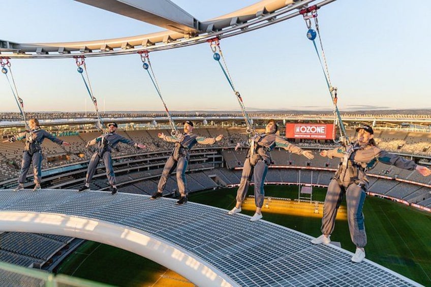 A circus performance on a high platform with performers in mid-air. 1
