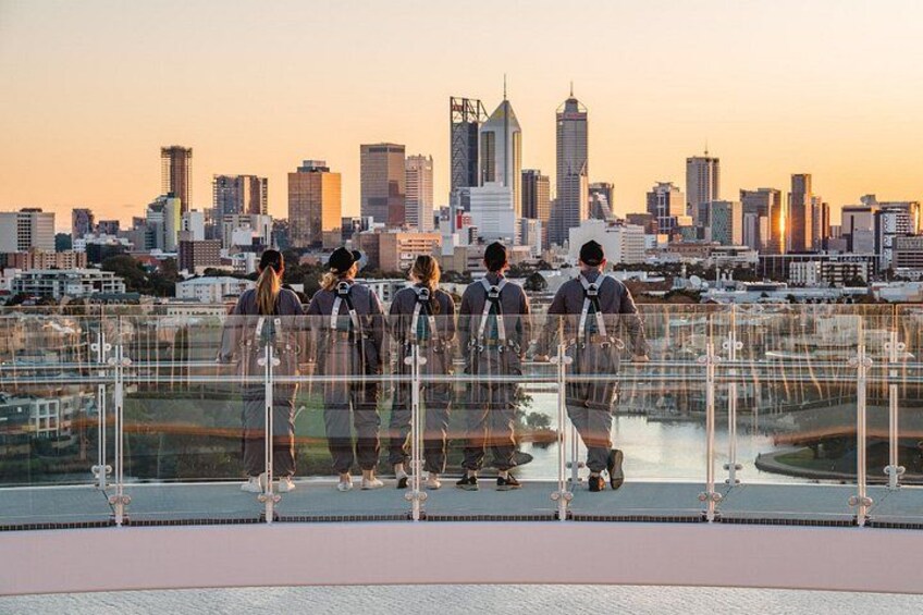 A group of people on a rooftop with a city skyline in the background. 4