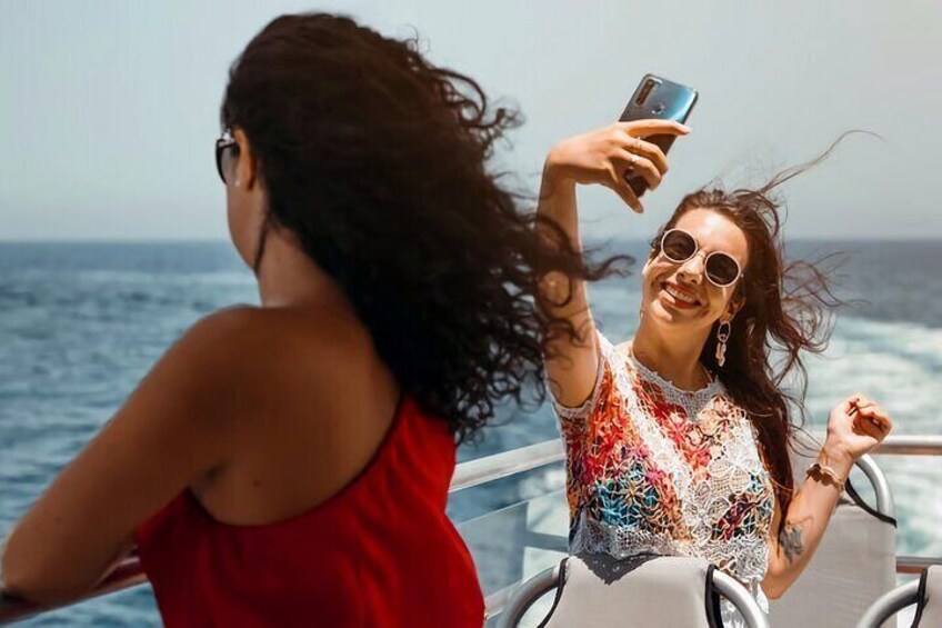 Una persona tomándose un selfie en un barco, con el océano al fondo. 2