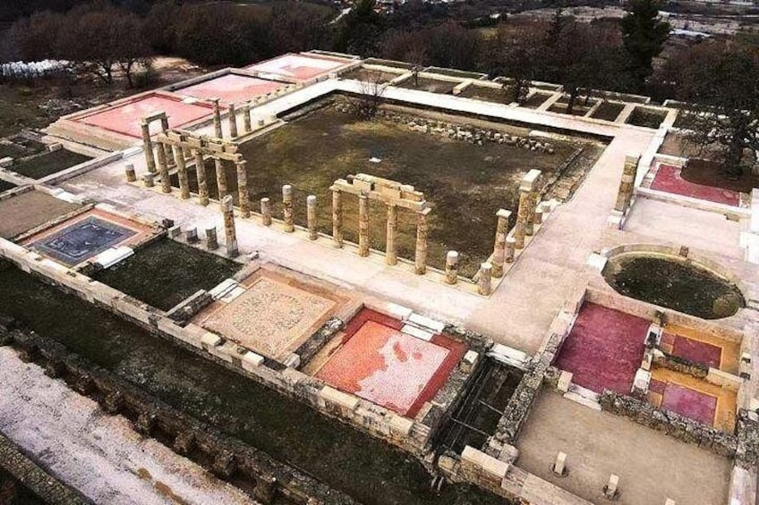 An ancient archaeological site with ruins, including columns and a large central square. 4