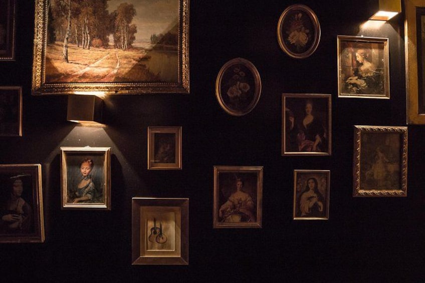 A gallery with framed artworks on the wall. 3