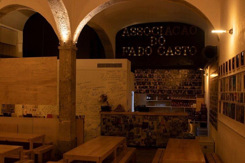 A cozy interior with arched ceilings, wooden tables, and a wall with handwritten notes. 5
