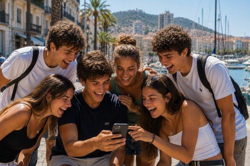 A group of people gathered around a smartphone, with a marina and buildings in the background. 1