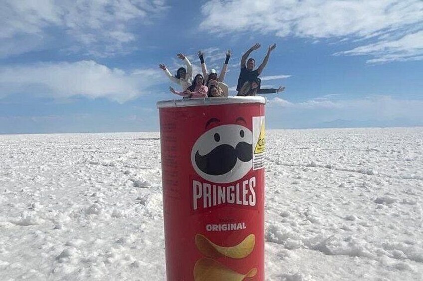 A Pringles can with a cartoon face on it, placed on a snowy landscape. 2