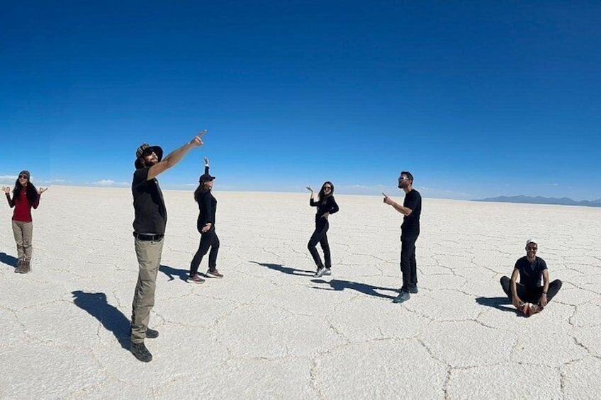 A group of people in a barren landscape with a clear sky. 3