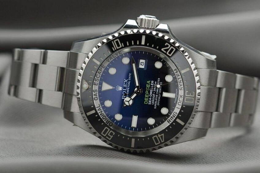A Rolex Oyster Perpetual Datejust watch with a blue dial and silver bracelet. 1