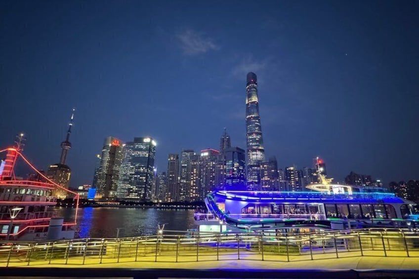A city skyline at night with illuminated buildings and a prominent tower. 4