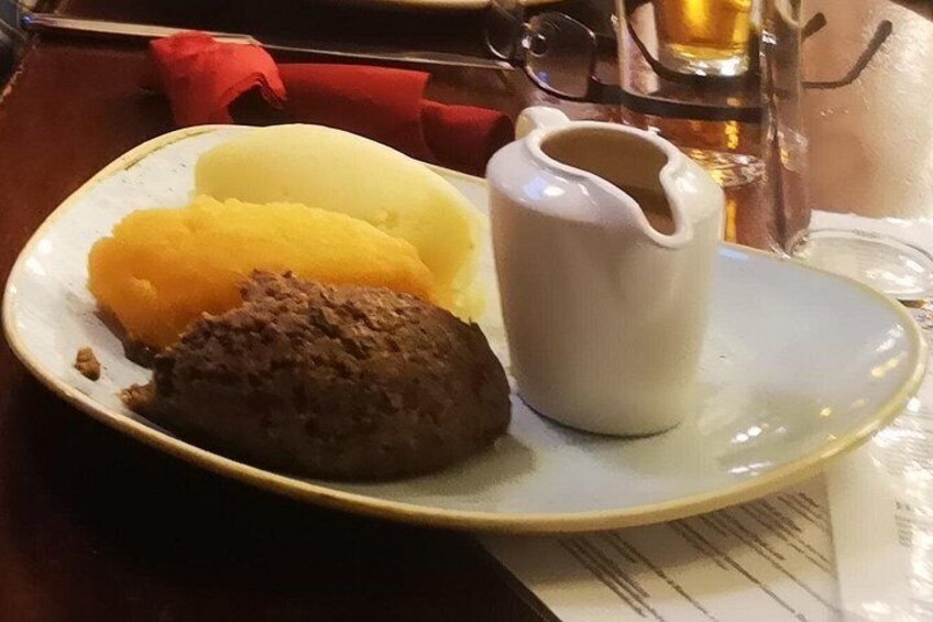 En tallrik med potatismos, en chokladdessert och en kanna sås. 5