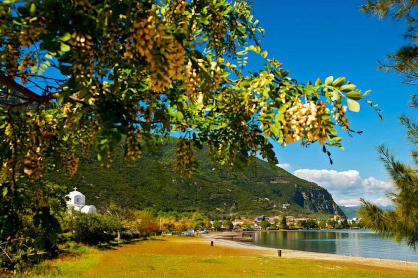 A lake, a white building, and a mountain. 5
