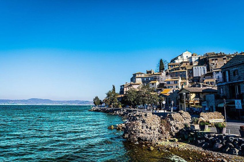 A coastal town with buildings on a cliff overlooking the sea. 1