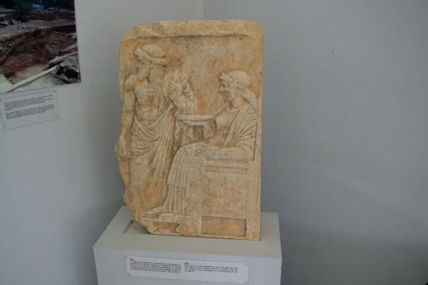A stunning marble relief depicting a moment of ancient life, housed in the Archaeological Museum of Nemea 1