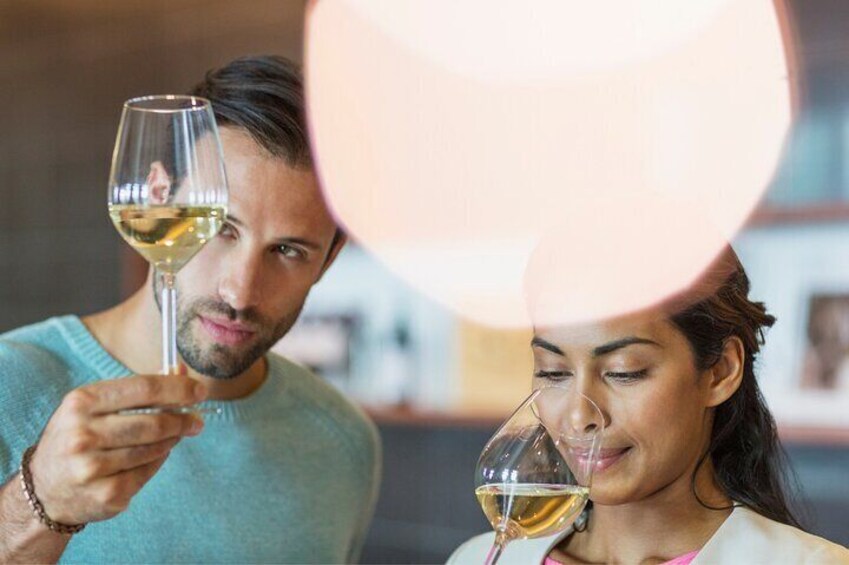 A moment of concentration as enthusiasts appreciate the art of wine tasting. 5