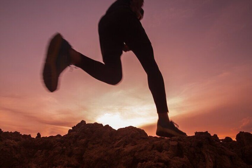 Capture the essence of perseverance with a runner silhouetted against a breathtaking sunset. This image embodies the timeless determination and spirit of the marathon. 3