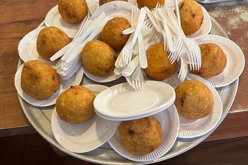 A tray of arancini (Rice Ball filled with Bolognese sauce and peas and mozzarella . 4
