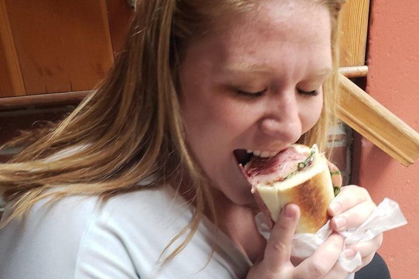 A person holding a sandwich. 5