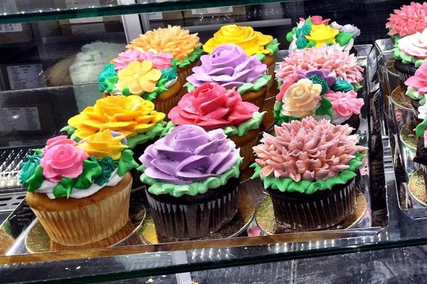 A display of cupcakes with colorful frosting decorations. 2