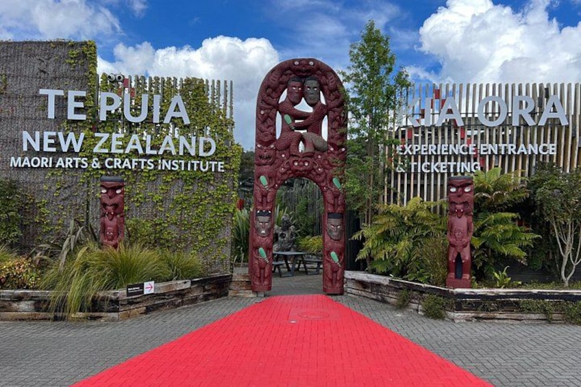 The entrance to Te Pua New Zealand Maori Arts & Crafts Institute with a red carpet and traditional Maori carvings. 2