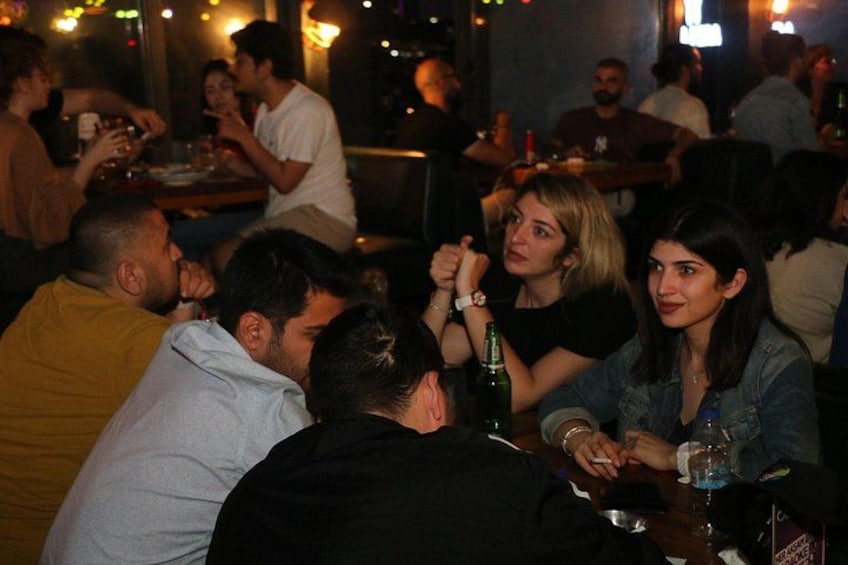A group of people sitting at a table in a restaurant. 2