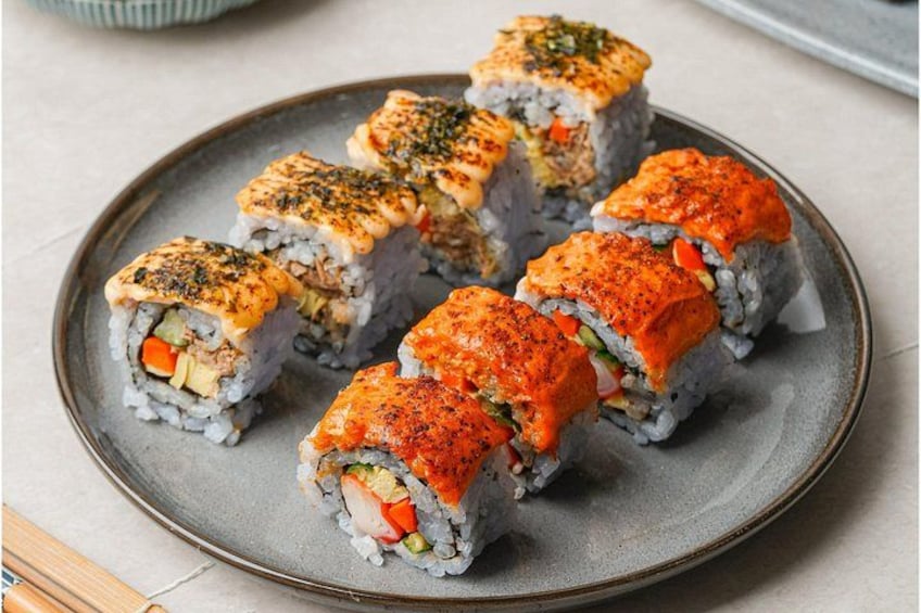 Sushi rolls with fish topping on a plate. 2