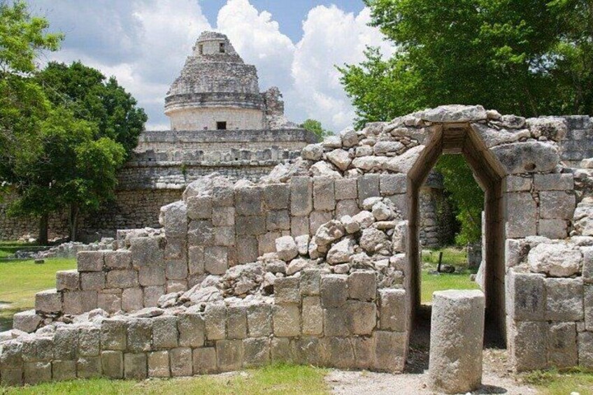 Ancient stone ruins with a large pyramid in the background. 3