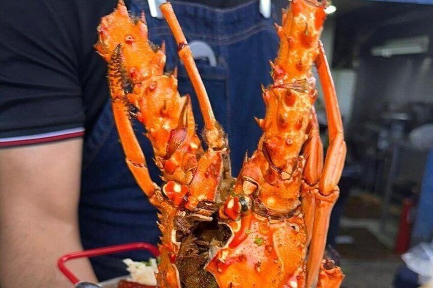 A large lobster with prominent claws and a reddish-orange shell. 5