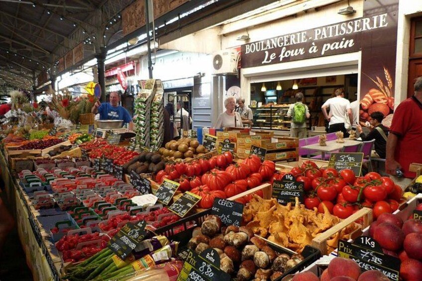 A market stall with fresh produce, including tomatoes, onions, and peppers. 3