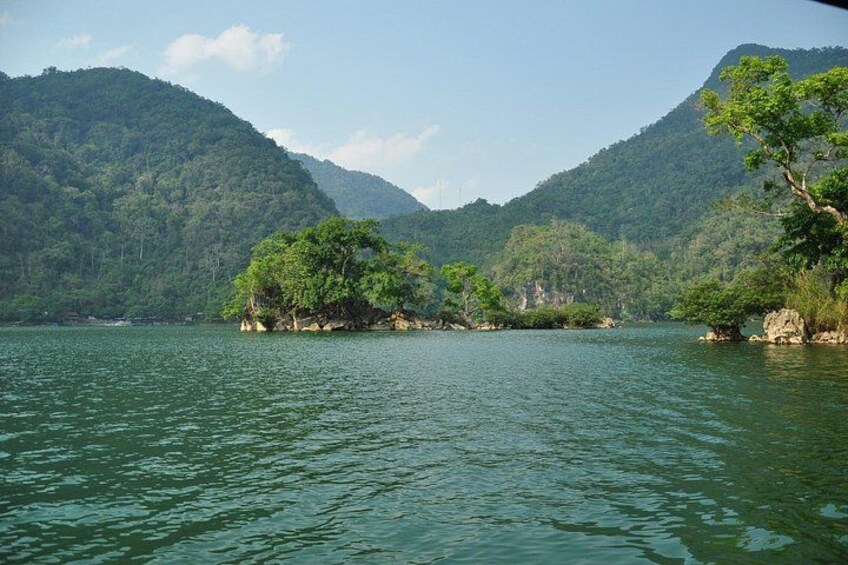 A calm lake surrounded by lush green hills. 3