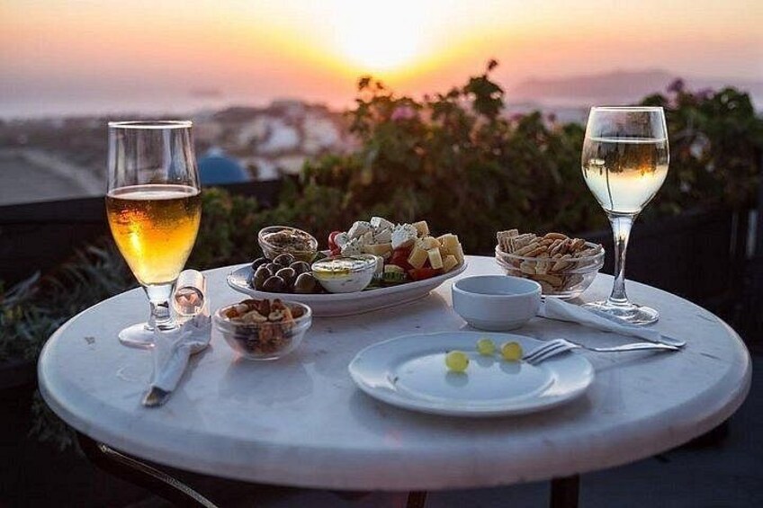 A table with food and drinks at sunset. 1