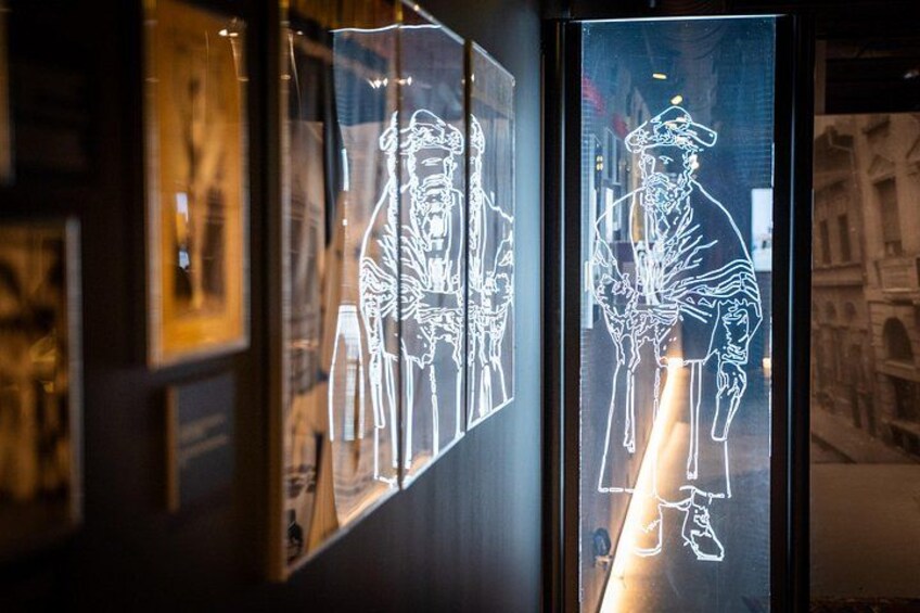 A glass display with illuminated outlines of figures. 2