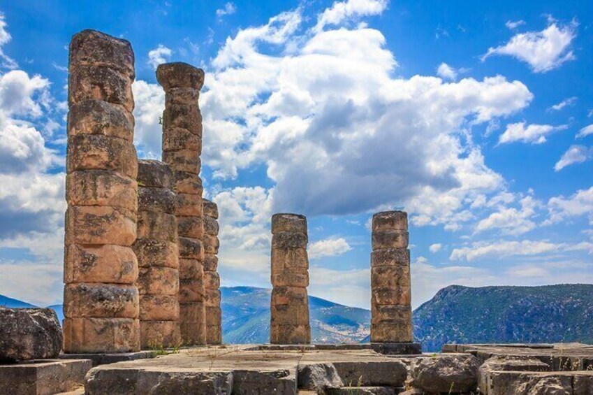 Ancient stone pillars in a historical site with a mountainous backdrop. 1