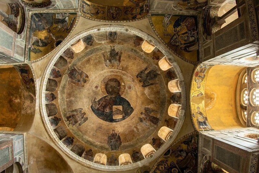 A domed ceiling with a central figure surrounded by smaller figures, intricate patterns, and architectural details. 3