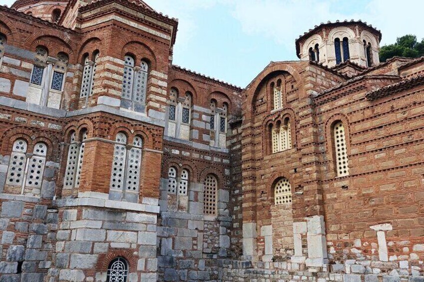Exterior view of the Hosios Loukas Monastery, highlighting its iconic red bricks and domes
 5