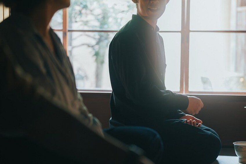 Two people sitting by a window with sunlight. 5