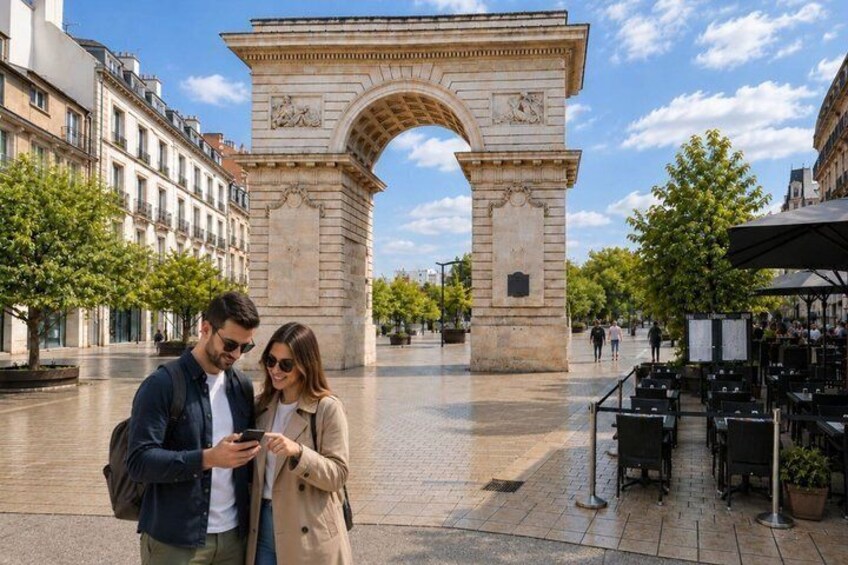 A couple standing in a square with a large historical archway in the background. 2