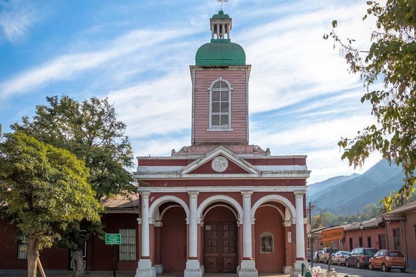 A church with a green dome and a clock tower. 3