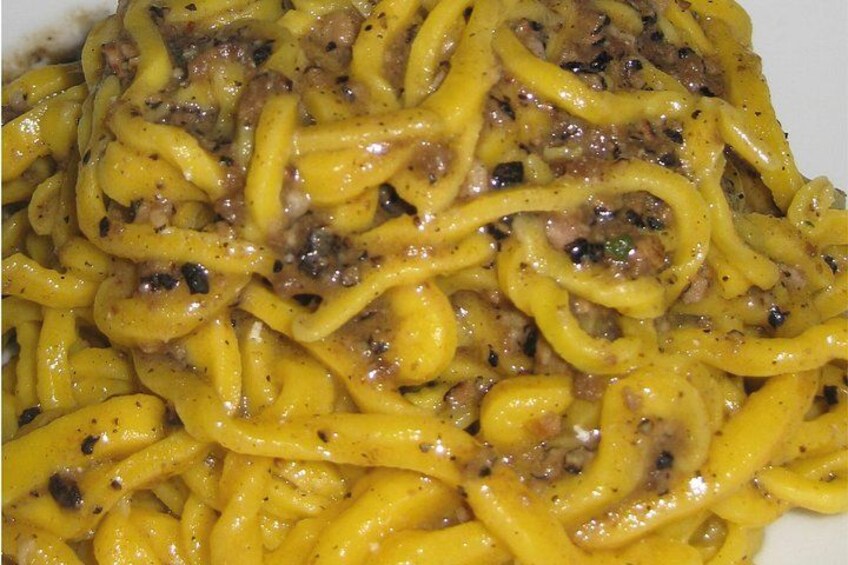 A plate of spaghetti with a meat sauce. 4