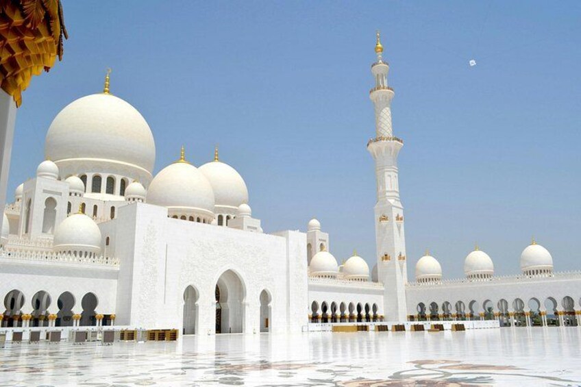En stor, hvid moské med flere kupler og et højt minaret. 3