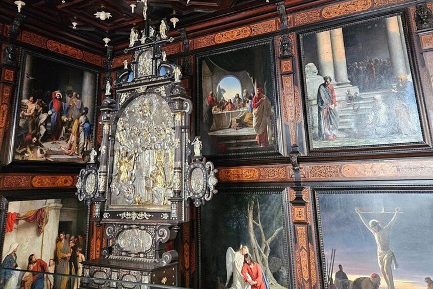 A church interior with ornate altars, religious paintings, and detailed woodwork. 5
