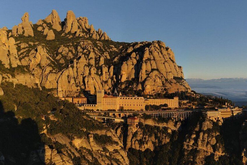 A mountain with a castle-like structure on top, surrounded by rocky terrain. 2