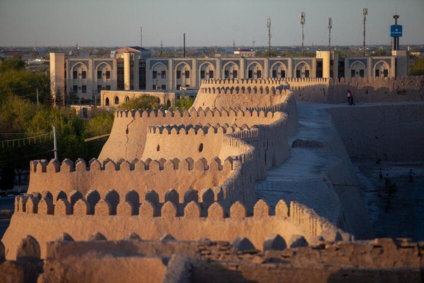 A fortified structure with a series of walls and a large building in the background. 4