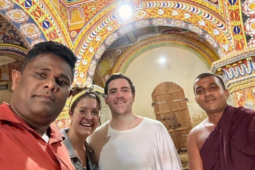 A group of people inside a building with ornate, colorful architecture. 3