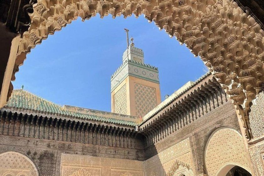 A mosque with intricate tile work and a minaret. 3