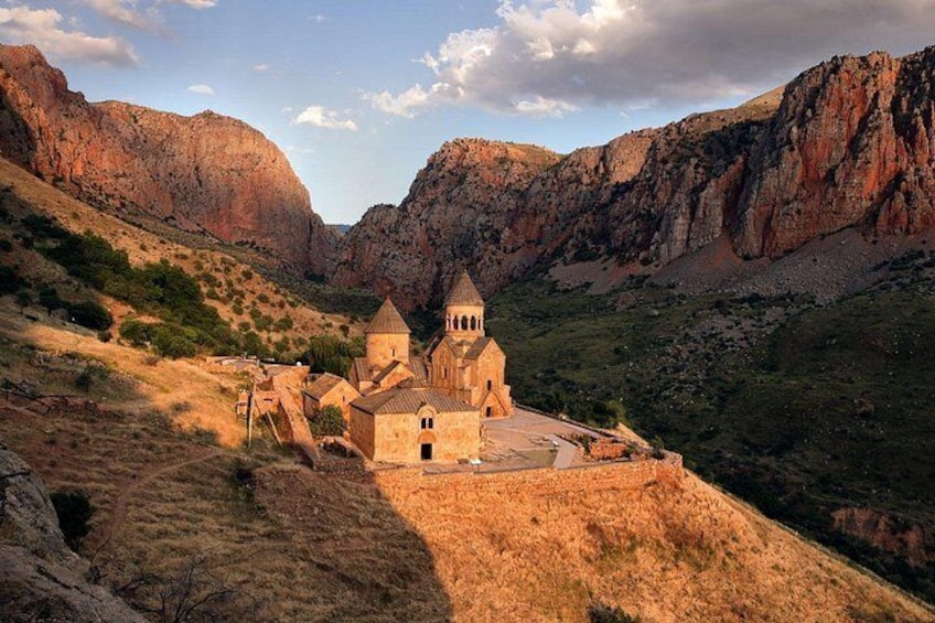 A church with a bell tower in a mountainous valley. 5
