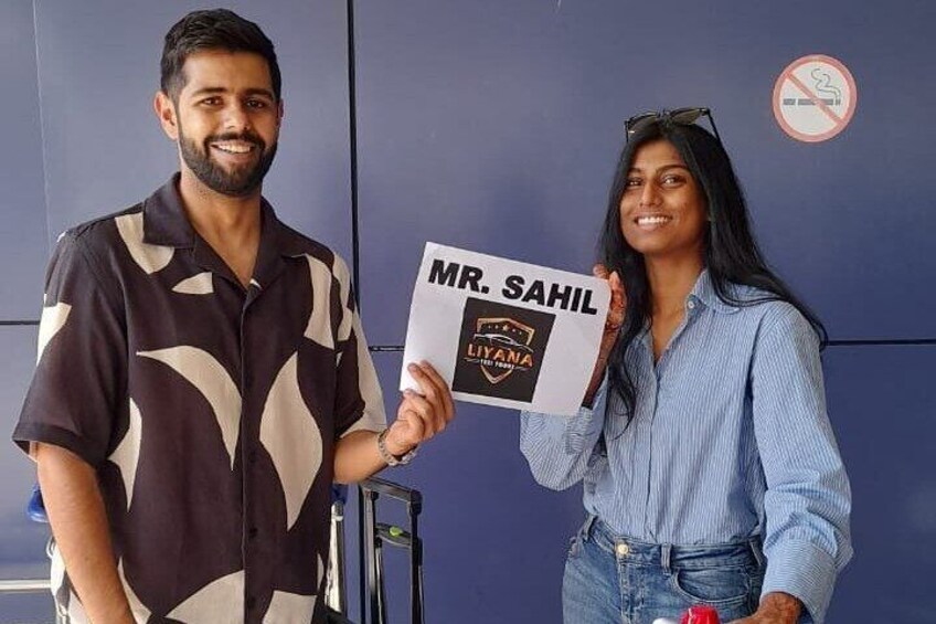 Two people holding a sign with 'MR. SAHIL' and 'LIVYQUA' on it. 2